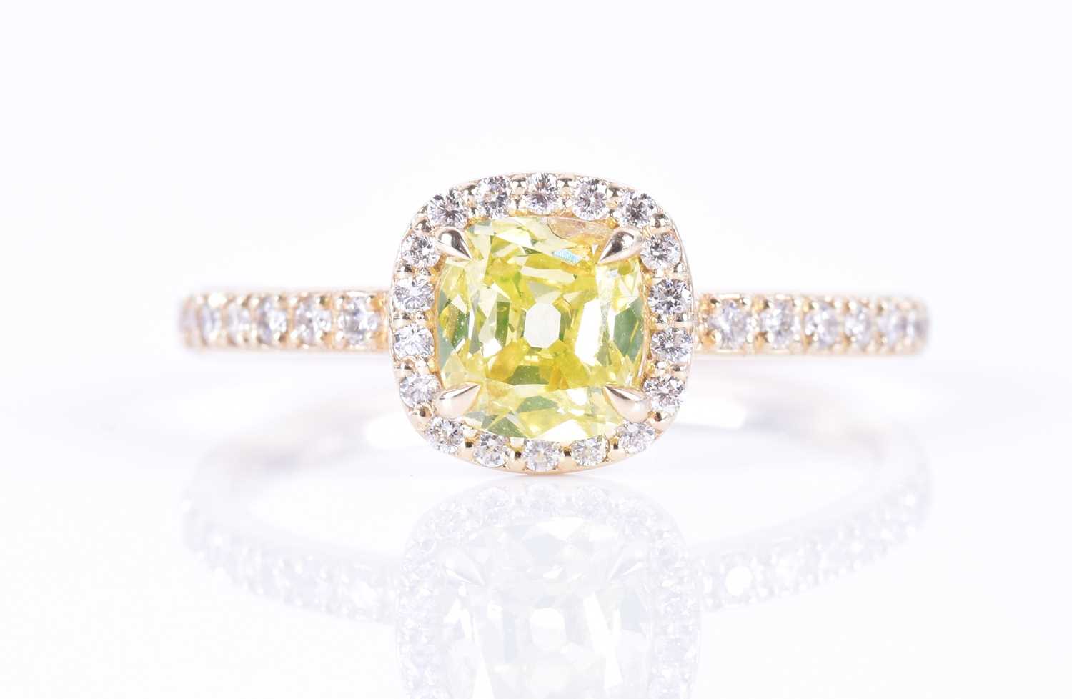 A 14ct yellow gold and yellow diamond halo ringset with a cushion-cut natural fancy intense yellow