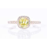 A 14ct yellow gold and yellow diamond halo ringset with a cushion-cut natural fancy intense yellow