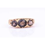 A 9ct yellow gold and smokey quartz ringset with three mixed round-cut gemstones, hallmarked to