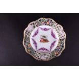 A late 19th/early 20th century Meissen porcelain reticulated cabinet plate, hand painted with a