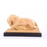 A mid-20th century yellow-glazed ceramic study of a lion making a kill, in the Art Deco style,