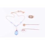 A yellow metal and moonstone tie pintogether with a 9ct yellow gold and blue paste necklace, a