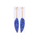 A pair of yellow metal and lapis lazuli drop earringseach suspended with a carved, tapered lapis