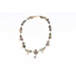 An unusual yellow gold, green tourmaline, and pearl necklacecomprised of alternating carved leaf-