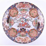 A large 20th century Arita ware porcelain charger, profusely decoarated in polychrome enamels with
