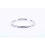 A platinum and diamond eternity ring, channel-set with round brilliant-cut diamonds, width 1.1 mm,