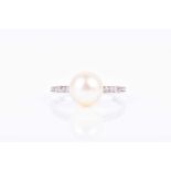 A Continental diamond and natural pearl ringset with a round white natural pearl of approximately