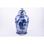 A Chinese blue and white vase and cover, late Qing, the cover with blossom, the vase with panels