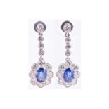 A pair of 18ct white gold, diamond, and sapphire drop earringseach set with a mixed oval-cut