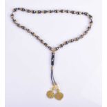 A Chinese painted wooden bead necklacecomprising of black, gold, and silver painted beads, with