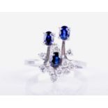 A 14ct white gold, diamond, and sapphire ringof unusual design, set with three mixed oval-cut