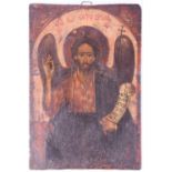 A 19th century painted wood icon depicting Christ, beneath text and holding a scroll displaying