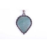A white metal and green hardstone pendantof pear-shaped design, the hardstone engraved with