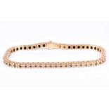 A yellow gold and diamond line bracelet, set with fifty five round brilliant-cut diamonds of