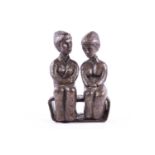 A contemporary bronze study of two figures seated on a bench, indistinctly signed, 32 cm high x 21