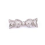 A late 19th / early 20th century diamond bow-shaped brooch, the openwork mount inset with old-cut