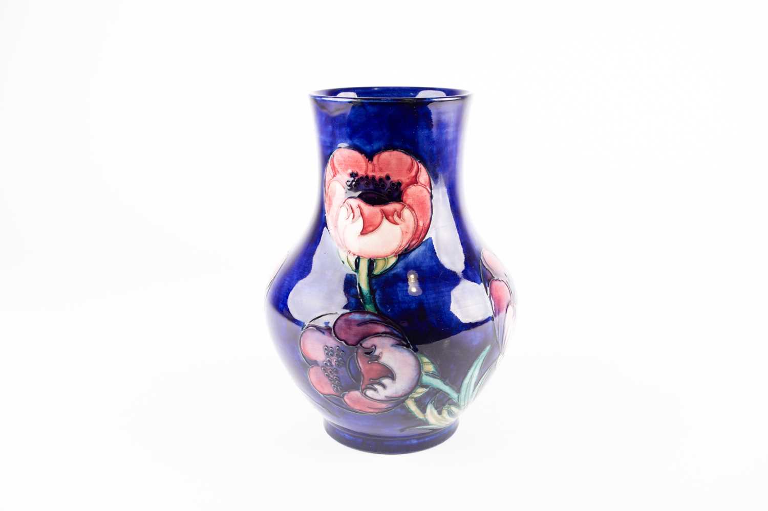 A William Moorcroft Big Poppy pattern vase, early 20th century, on a shaded dark blue ground, blue