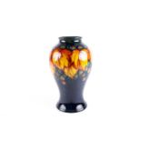 A William Moorcroft flambé 'Leaf & Berry' vase, circa 1925/30, of inverted baluster form, the