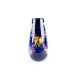 A Walter Moorcroft 'Leaf & Berry' pattern vase, mid 20th century, of tapered cylindrical form, the