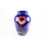 A large Moorcroft Poppy pattern vase, mid 20th century, decorated against a shaded blue ground, blue