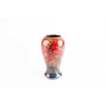 A Moorcroft Flambé Lily pattern vase, early to mid 20th century, of tapering form leading to a