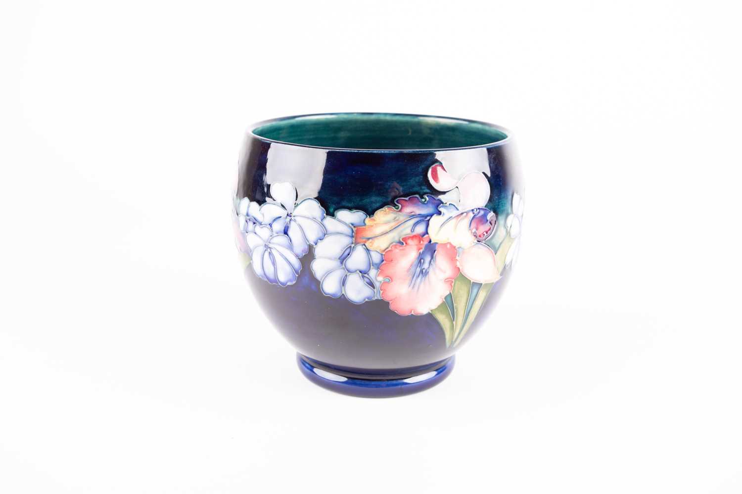 A Walter Moorcroft Orchid pattern jardiniere, on a shaded blue ground, blue inscribed initials,