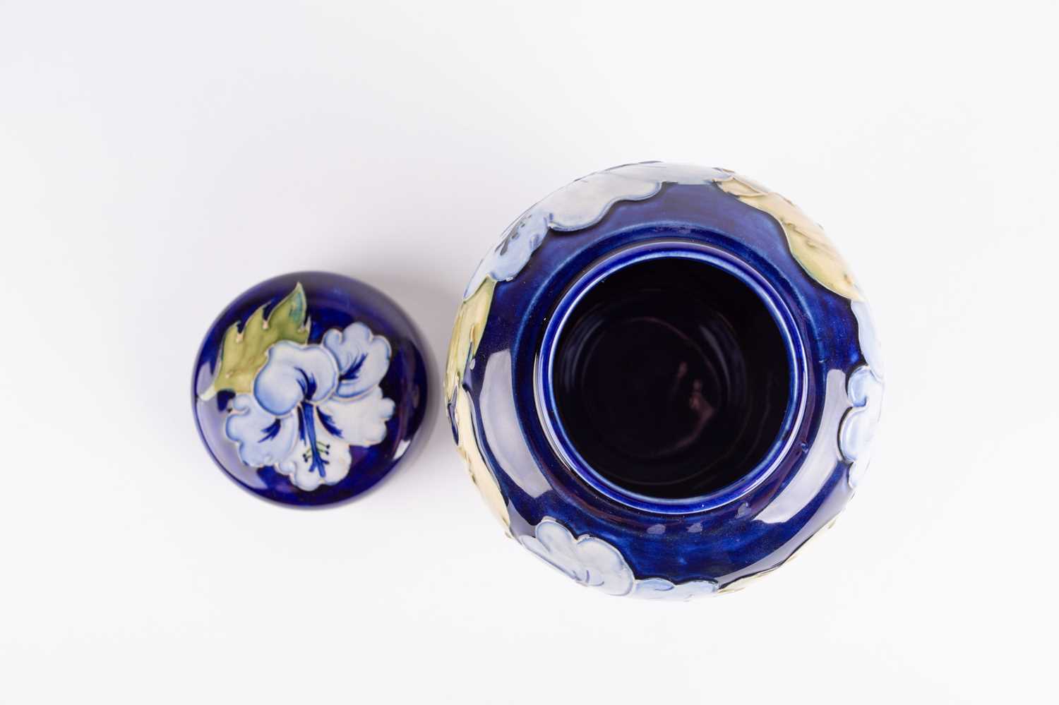 A Moorcroft Hibiscus pattern ginger jar and cover, the pale blue flowers against a dark blue ground, - Image 2 of 4
