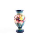 An early Walter Moorcroft 'Orchid' pattern vase, second quarter 20th century, with an everted rim