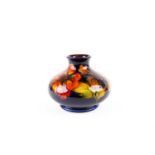 A Walter Moorcroft flambé 'Hibiscus' pattern vase, mid 20th century, of compressed form, decorated