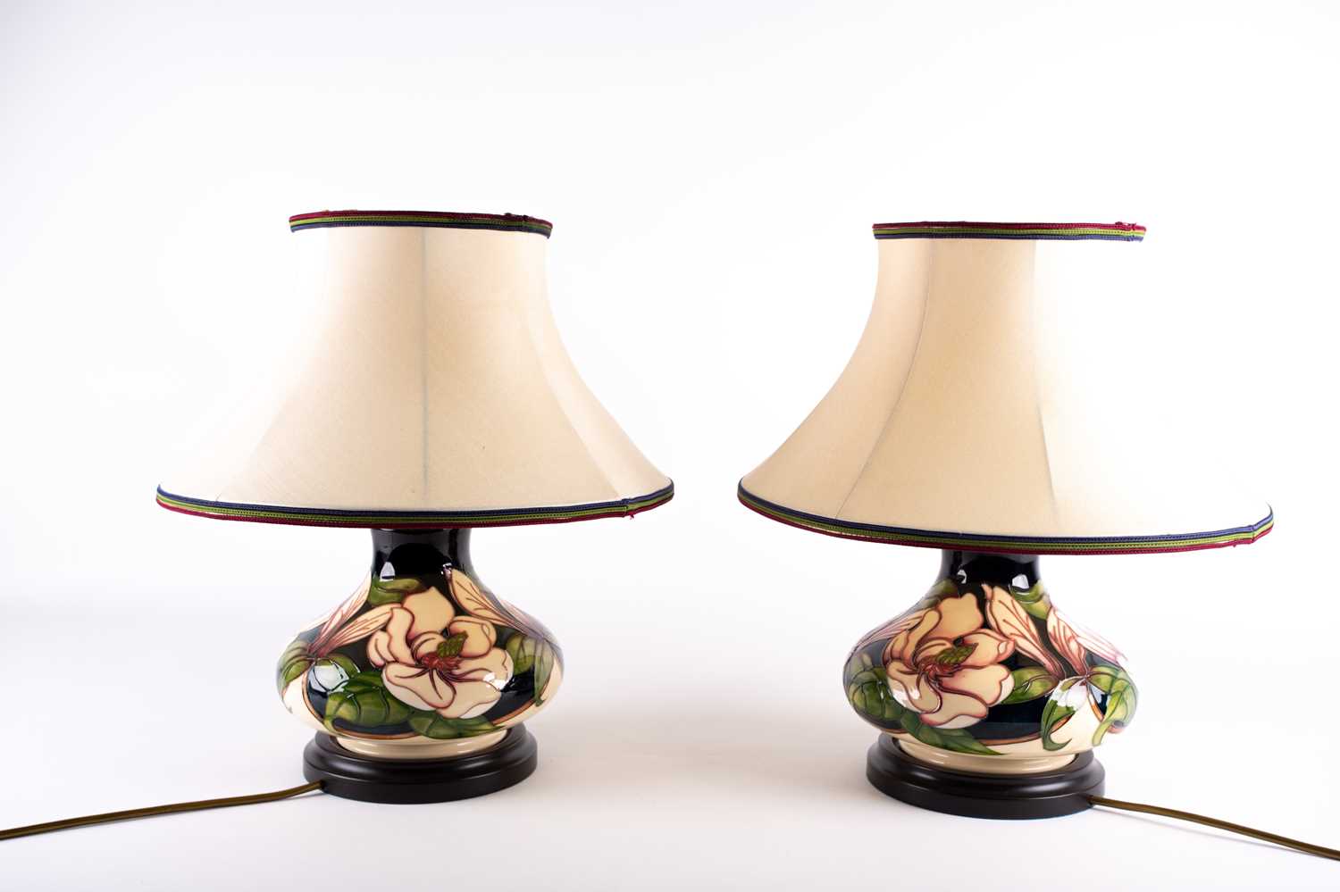 A pair of Moorcroft 'Magnolia' pattern table lamps, late 20th century, of compressed form, the