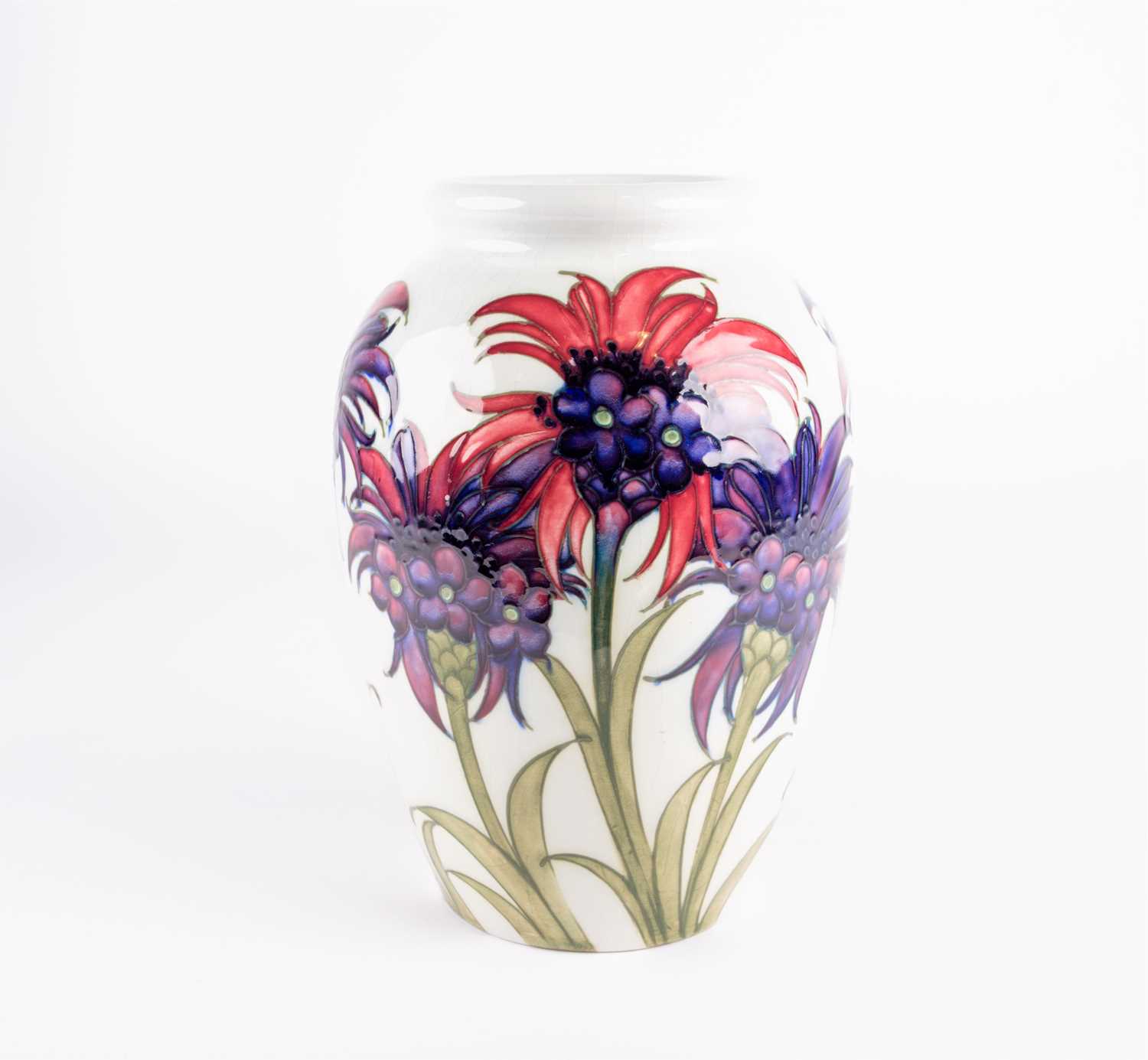 A William Moorcroft 'Cornflower' pattern vase, circa 1930, decorated on a white ground, inscribed