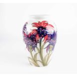 A William Moorcroft 'Cornflower' pattern vase, circa 1930, decorated on a white ground, inscribed