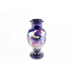 A Moorcroft Orchid pattern vase, mid 20th century, the yellow, violet and blue flowers against a