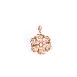 A 15ct yellow gold and seed pearl pendant / brooch, of circular design, centred with a floral