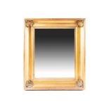 A 19th century gilt framed wall mirror, with inverted cushion shaped frame and shell mounted