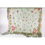 A mid to late 20th century pale green silk scarf, with painted autumn leaves and fringed decoration,