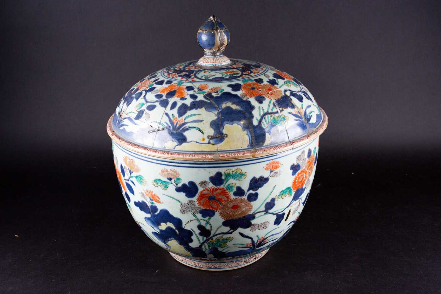 A Japanese imari bowl and cover, circa 1680, the domed cover with pointed knop, decorated throughout