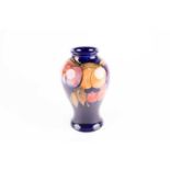 A Moorcroft Wisteria pattern vase, early 20th century, of baluster form, with part flambé