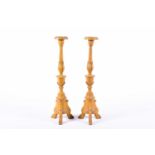 A pair of 16th century style tall church candlesticks, with acanthus leaf adornments and turned