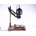 A vintage Leitz Focomat I Enlarger, with extending movement mounted to a wooden board, 78 cm high.