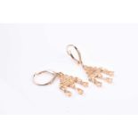 A pair of yellow gold and diamond chandelier drop earrings, the tapered mounts inset with fancy