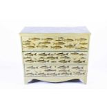 A Liberty of London painted chest of drawers, decorated all over with applied fish on a sage green