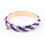 A yellow gold and cobalt blue enamel bangle, of twisted design, unmarked (tests as 18ct gold),