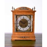 A late 19th century walnut cased bracket clock by Lenzkirch, with dome top cornered by four brass