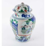 A Kangxi Famille verte vase and cover, late 17th century, painted with females conversing, reading