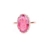 An 18ct rose gold, diamond, and pink tourmaline ring set with an oval-cut tourmaline, four-claw