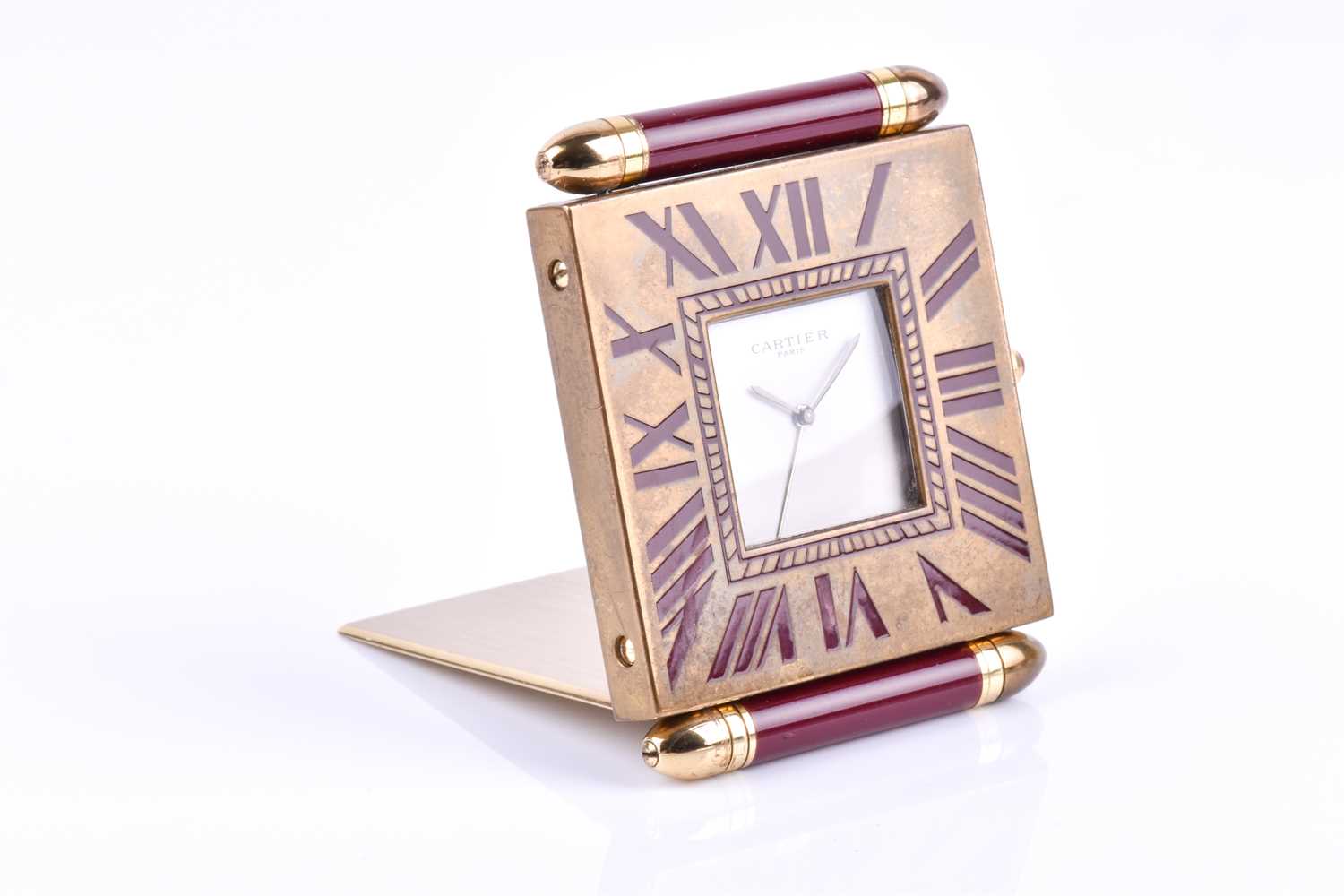 A Cartier travel clock, of square form with gilt metal case with claret lacquered Roman numerals, - Image 3 of 13