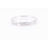 Tiffany & Co. A silver ring, engraved '727 Fifth Avenue, New York, New York 10022', size N 1/2.