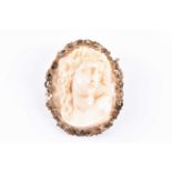 A late 19th century carved ivory cameo style broochdecorated with a carved profile of a Classical