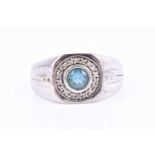 A 9ct white gold and blue topaz gents ring, the squared mount inset with a round-cut stone, within a